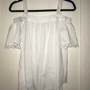 White off the shoulder shirt; felt balls on sleeve